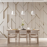 A minimalist geometric wallpaper featuring a repeating pattern of overlapping diamond shapes in a neutral beige tone.