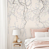 A serene wallpaper design featuring delicate cherry blossom branches in soft gray and white tones against a muted background.