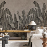 wallpaper featuring a row of large, stylized banana leaves in shades of gray against a textured background.