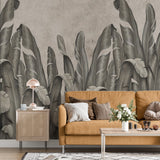 wallpaper featuring a row of large, stylized banana leaves in shades of gray against a textured background.