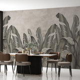 wallpaper featuring a row of large, stylized banana leaves in shades of gray against a textured background.