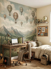 Vintage adventure wall mural shown in a bright kids room with hot air balloons, mountains, winding river, waterfalls and campsite.