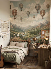 Mountain and hot air balloon wallpaper installed behind a study desk in a teen bedroom with vintage travel inspired decor.