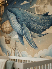 Close-up of watercolor blue whale wallpaper with decorative patterns, moon, stars and vintage hot air balloon.