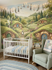 Bunny burrow nursery wallpaper with rabbits, cottage doors, wildflowers and rolling hills behind a white crib.
