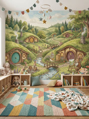 Bunny village wallpaper with watercolor green hills, cozy rabbit homes and stream behind a children’s study desk.