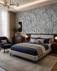Black and white banana leaves wallpaper in a designer bedroom.