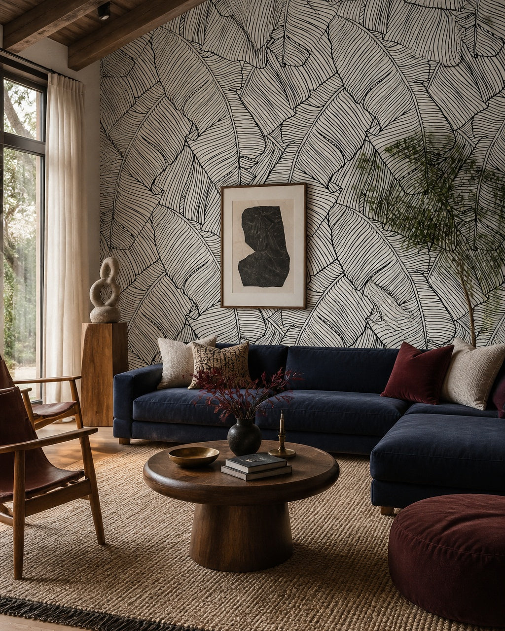 Black and white banana leaves wallpaper in a designer living room.
