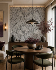Black and white banana leaves wallpaper in a refined dining area.