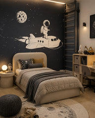 Astronaut riding a space shuttle kids’ wall mural in a boy’s bedroom.
