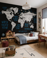 Black and white world map wallpaper in a girl’s bedroom.