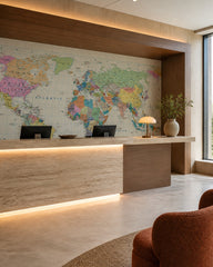 Political world map wallpaper at a hotel reception desk.