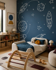 Hand-drawn rockets & planets navy space wallpaper in a toddler bedroom with a child-sized bed.