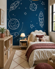 Hand-drawn rockets & planets navy space wallpaper in a girl’s bedroom.