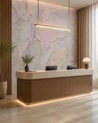 Pink and gold marble wallpaper at a hotel reception desk.