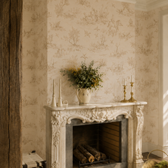 Beige toile de jouy wallpaper around a carved French stone fireplace.