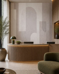Pastel geometric shapes wallpaper at a hotel reception desk.