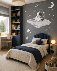 Astronaut in a flying saucer space wall mural in a girl’s bedroom.
