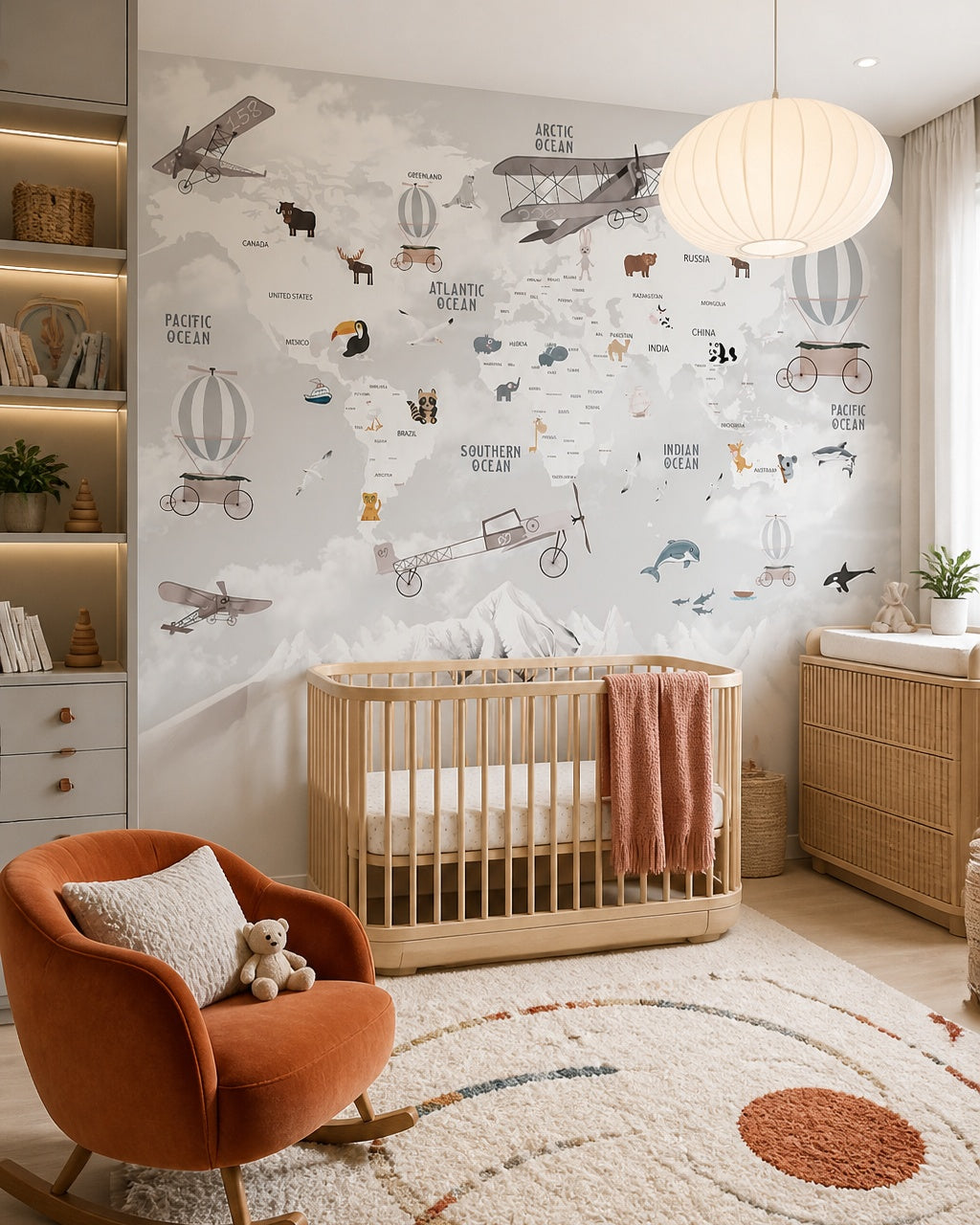 Vintage aviation & wildlife world map wall mural in a modern nursery with a crib.