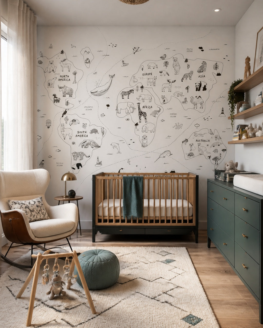 Hand-drawn animals of the world map wall mural in a modern nursery with a crib.