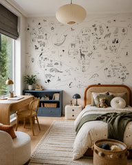 Hand-drawn animals of the world map wall mural in a girl’s bedroom.