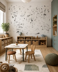 Hand-drawn animals of the world map wall mural in a children’s playroom.