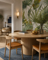Large palm leaves wallpaper in a refined dining area.