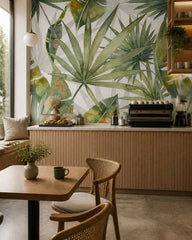 Large palm leaves wallpaper in a specialty coffee shop.