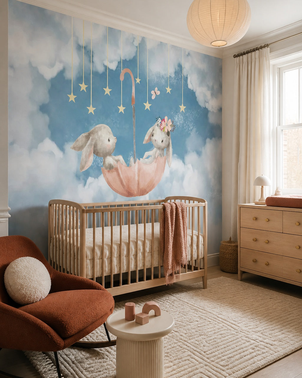 Bunnies in umbrella wallpaper in a modern nursery with a crib.