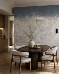 Blue and grey concrete wallpaper in a refined dining area.