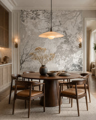 Grey leaves and branches wallpaper in a refined dining area.