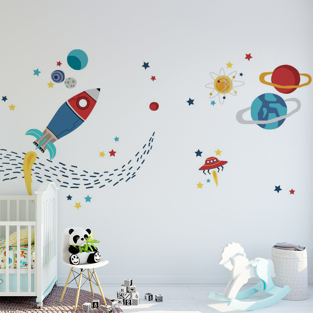 Colorful rocket, planets, stars and UFO space wall mural in a bright children’s playroom