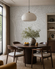 White blossom tree wallpaper in a refined dining area.
