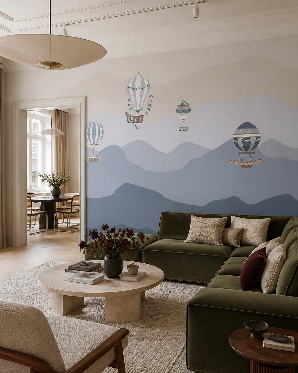 Vintage balloons over blue mountains wallpaper in a designer living room.