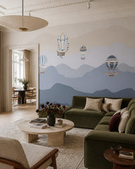 Vintage balloons over blue mountains wallpaper in a designer living room.