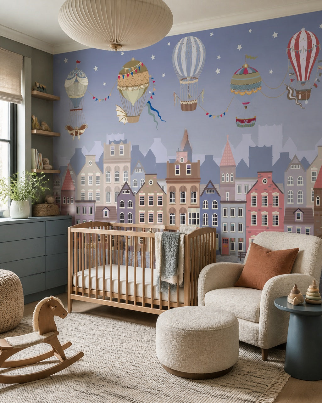 Vintage balloons over the twilight town wallpaper in a modern nursery with a crib.