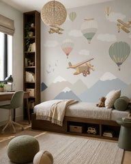 Vintage airplanes and balloons kids room wallpaper in a boy’s bedroom.