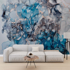 Ocean blue, teal and gray alcohol ink wall mural with rose-gold accents in a modern living room