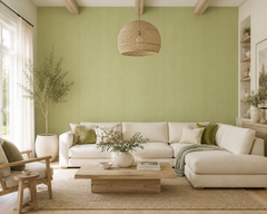 Pistachio green textured wallpaper in a bright living room with white sofa and olive tree.