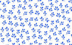 Repeating cobalt blue leaf wallpaper pattern on a warm cream background.