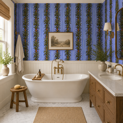 Blue stripe botanical wallpaper in a bathroom with freestanding tub and wainscoting.