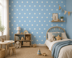 Powder blue daisy wallpaper in a cozy kids room with rattan bed and toys.