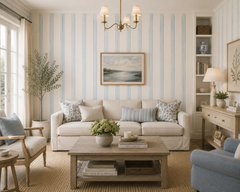 Blue and cream stripe wallpaper in a classic living room with chandelier and blue armchair.