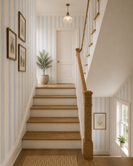 Blue and cream stripe wallpaper along a staircase with oak steps.