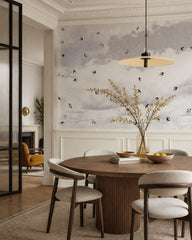 Swallows in flight wallpaper in a refined dining area.