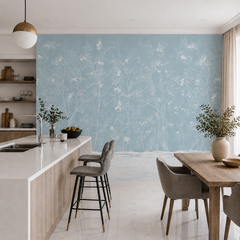 Dusty blue chinoiserie blossom wallpaper in an open kitchen with island and dining table.
