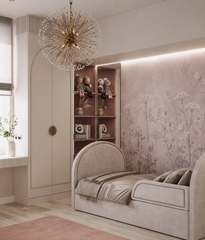 Dusty pink wildflower wallpaper in a girls’ room with arched daybed and pink rug.