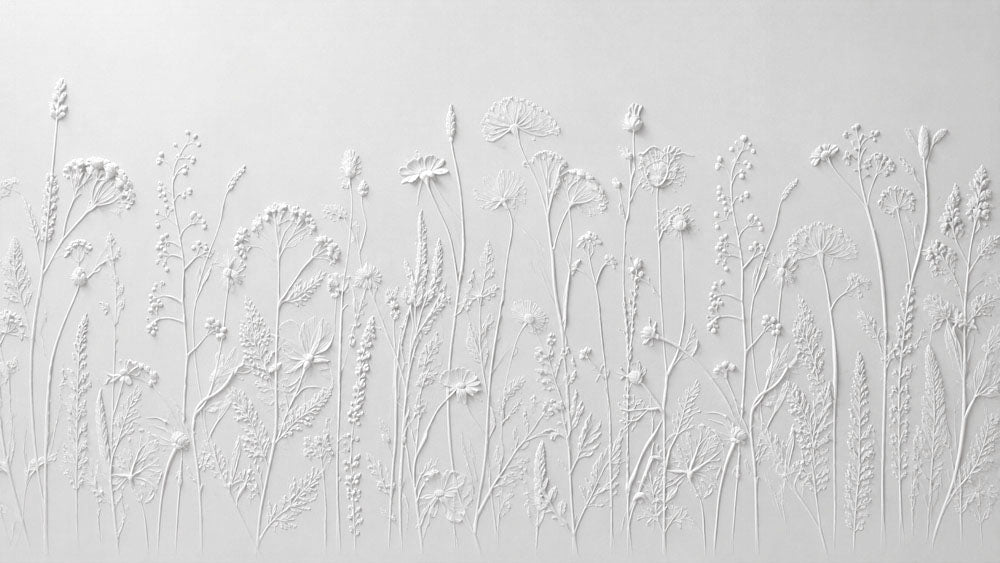White wallpaper with a 3D embossed effect of wildflowers and grasses resembling sculpted plaster.