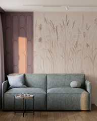Beige meadow grass wallpaper behind a teal sofa in a modern living room.
