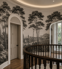 Black and white Italian toile wallpaper on a curved staircase landing.